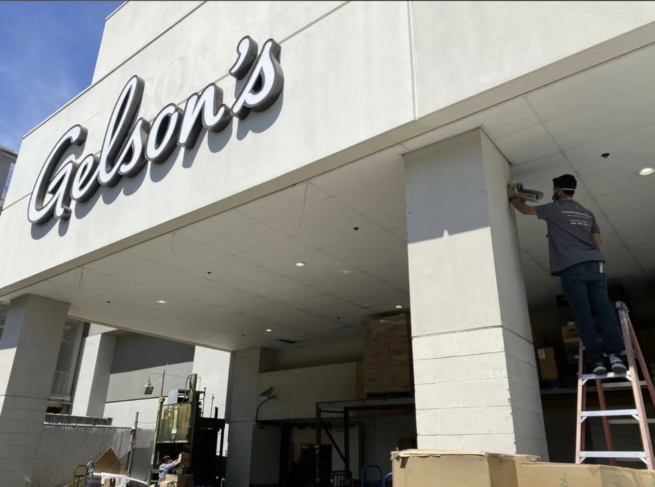 Three Factor Security technician working on an exterior security camera at Gelson’s in Los Angeles, California
